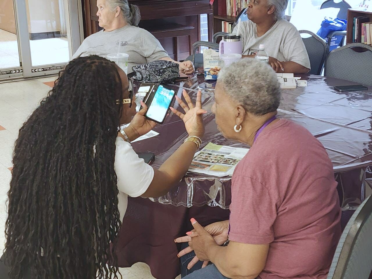 A senior woman smiling on a video call with her smartphone